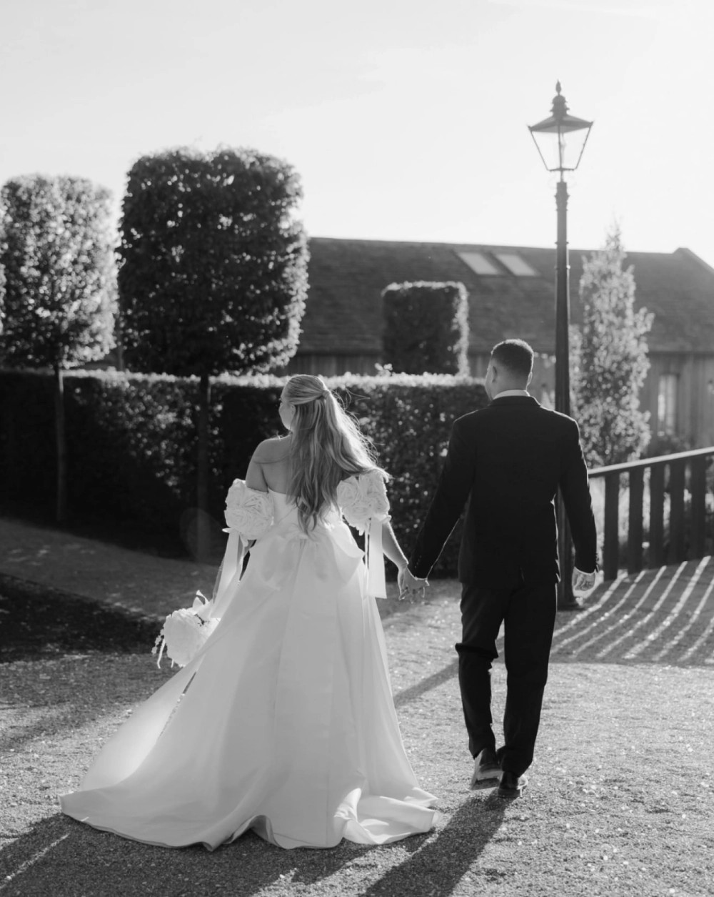 Morgan Davies Bridal Сouple wearing a white gown and a black suit